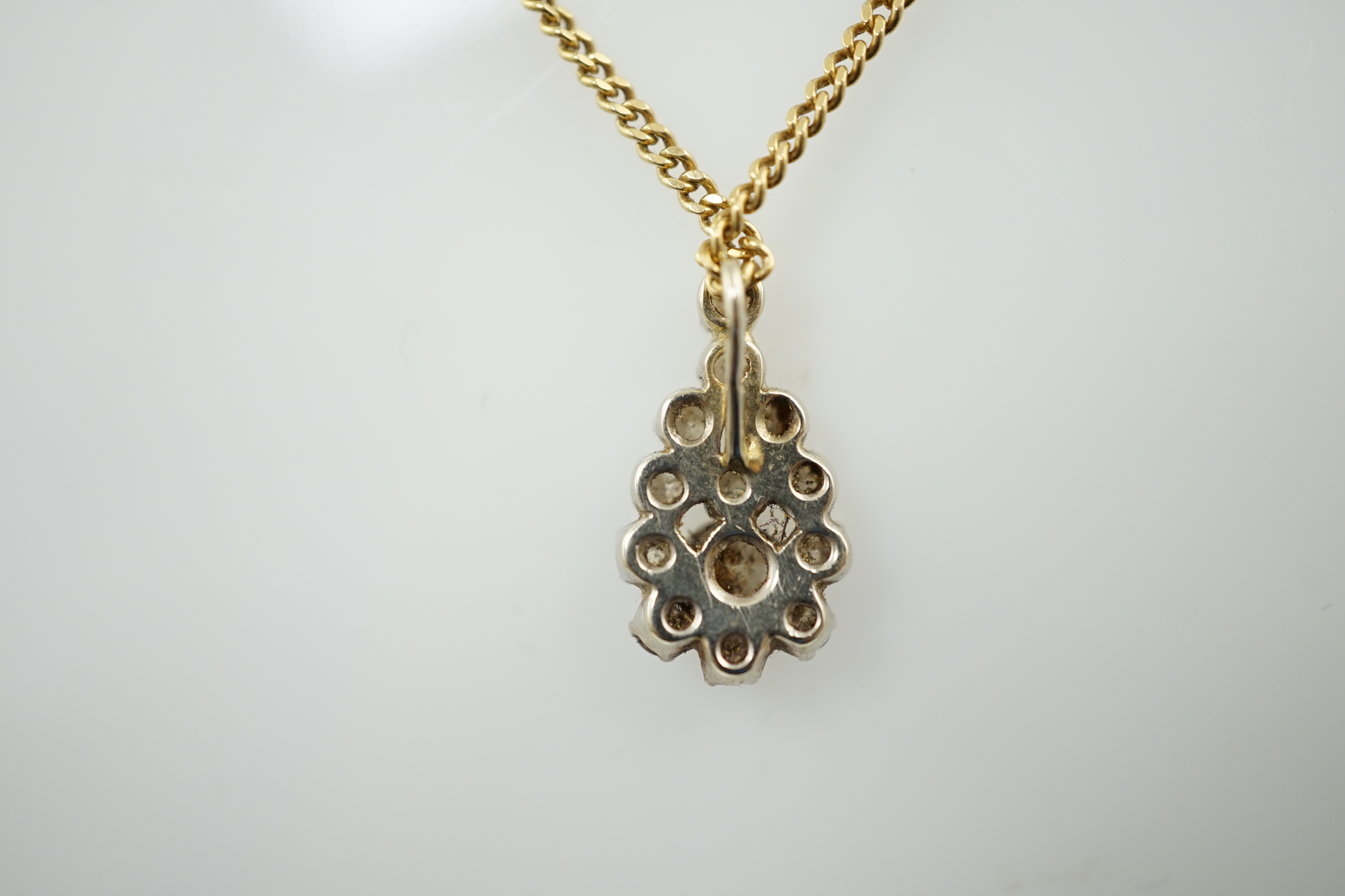 An early to mid 20th century French 18k gold and diamond cluster set pendant, on a French 18k gold chain